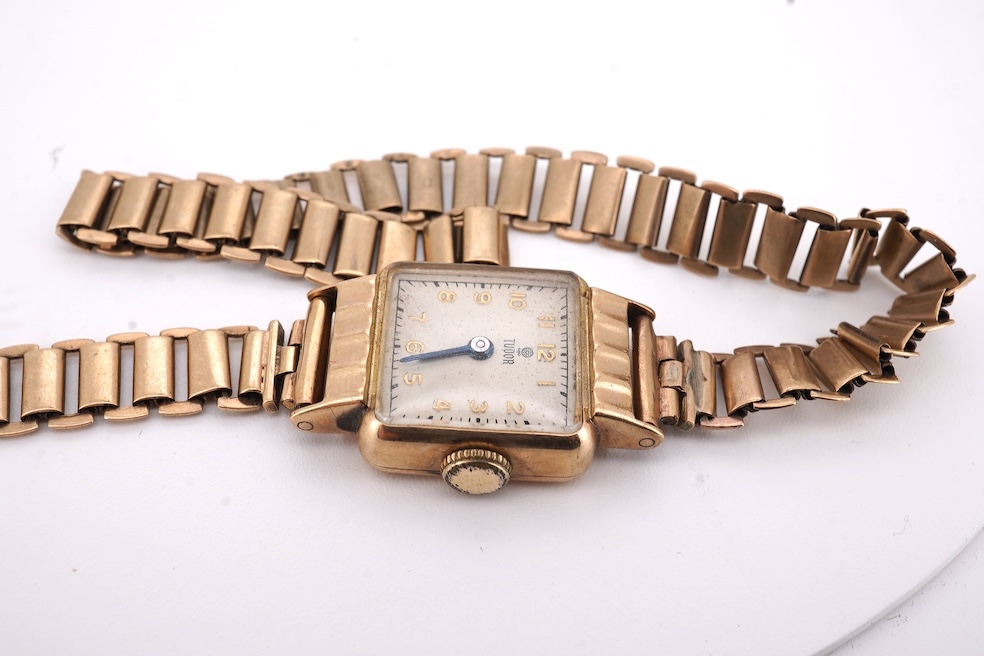 A lady's 1950's 9ct gold Tudor manual wind wrist watch, with Arabic dial, case diameter 18mm, on a damaged 9ct gold bracelet, gross weight 18.6 grams, together with a lady's 18ct gold Buren manual wind wrist watch, on a